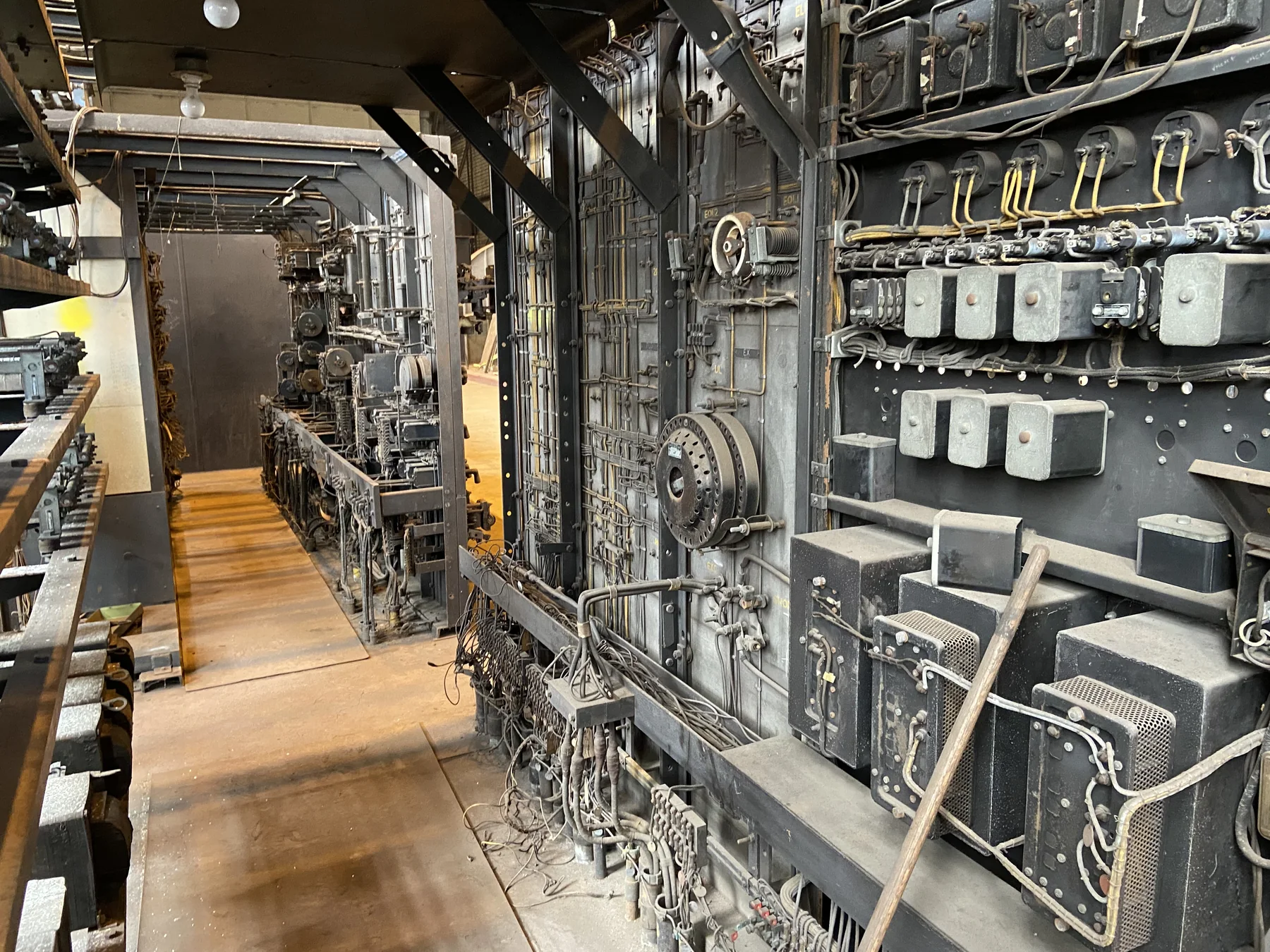 Industrial electric control panel with rows of switches, meters, and wiring, illustrating equipment monitoring for an industrial IoT and energy course.