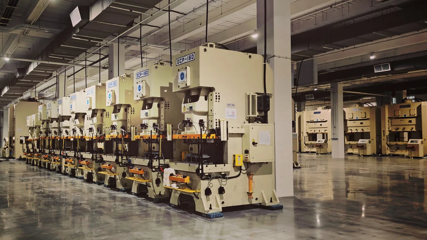 Rows of industrial machines across a factory production floor.